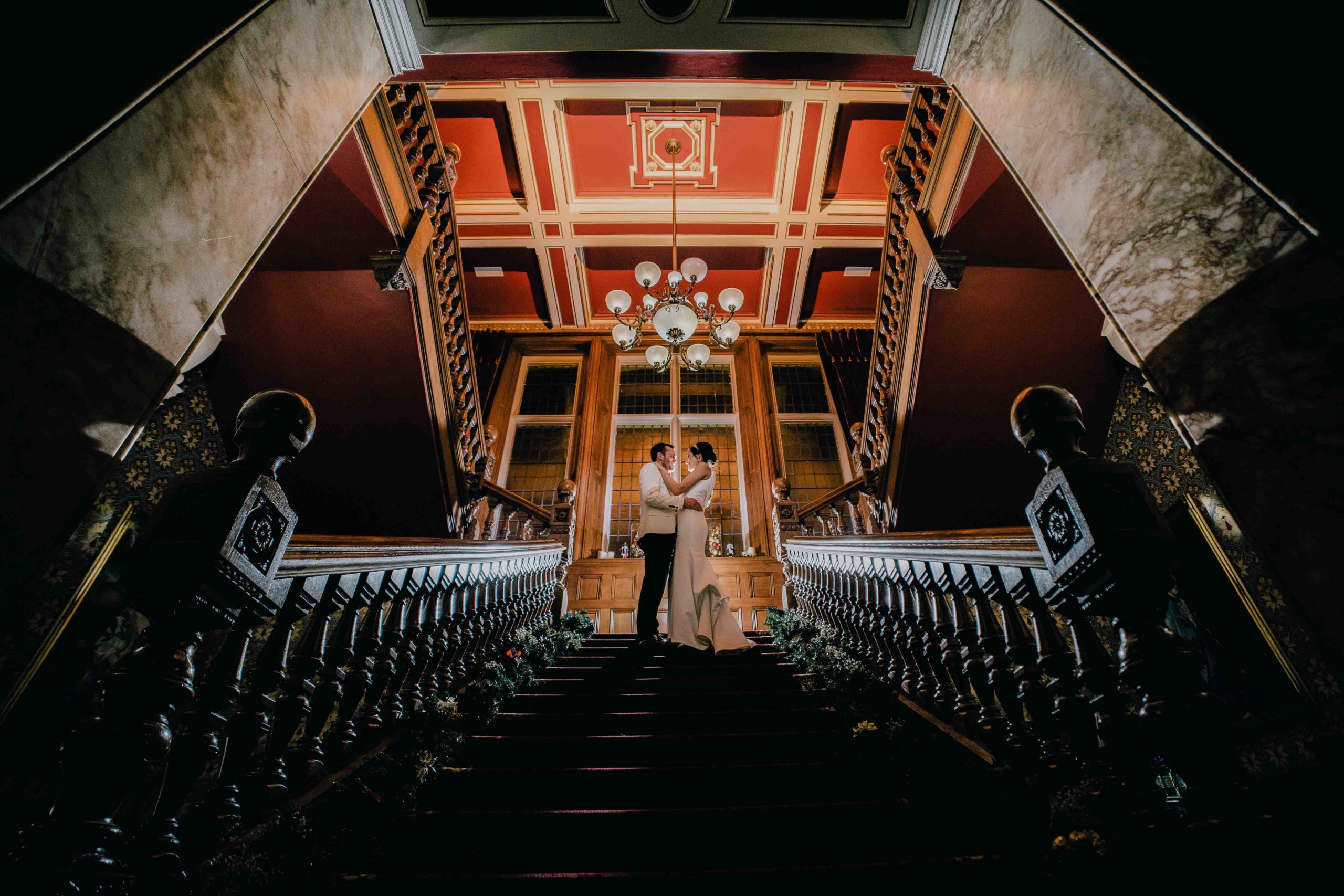 Stunning wedding photograph on the stairs at Rossington Hall