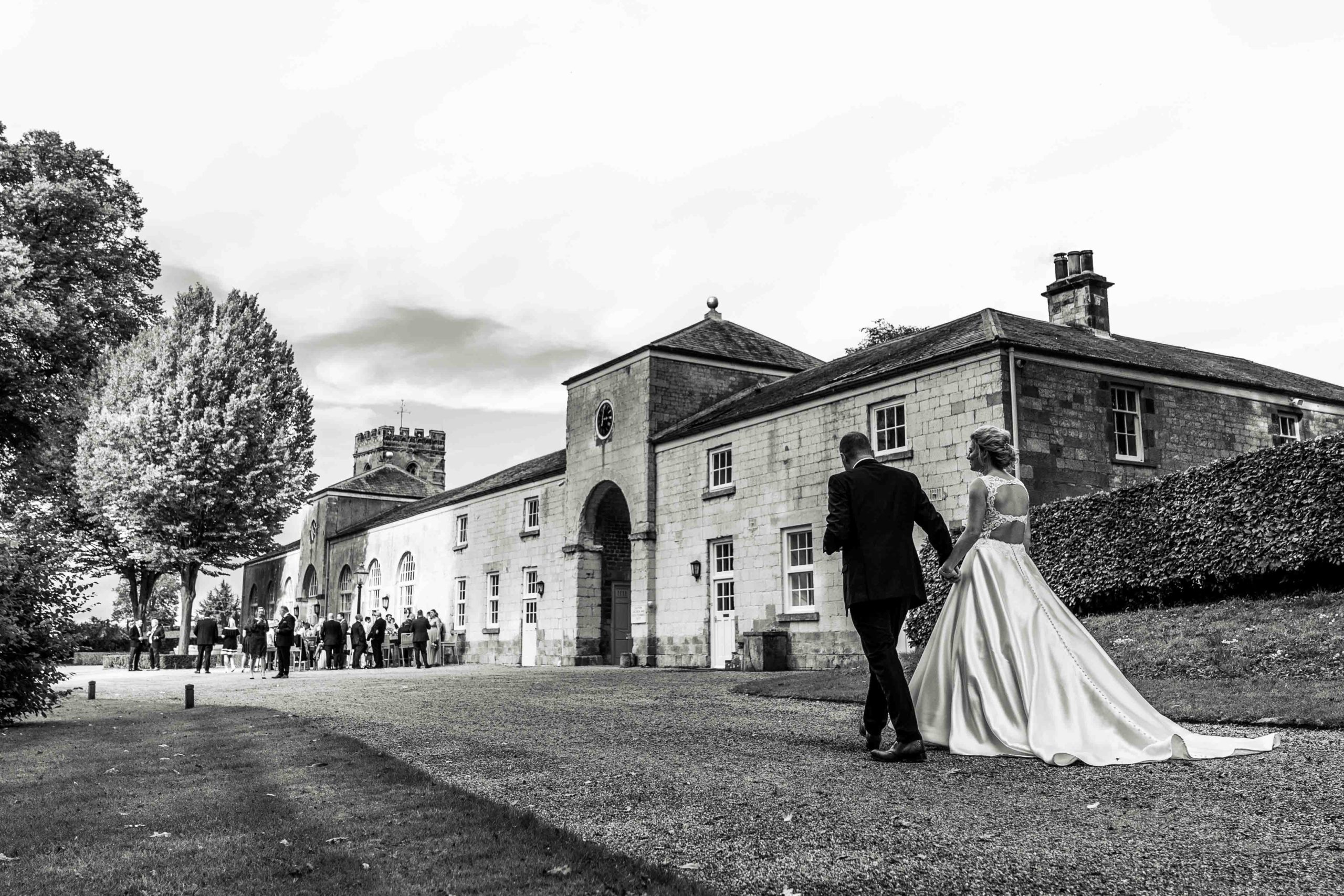 Wedding couple walking past The Orangery at Settrington