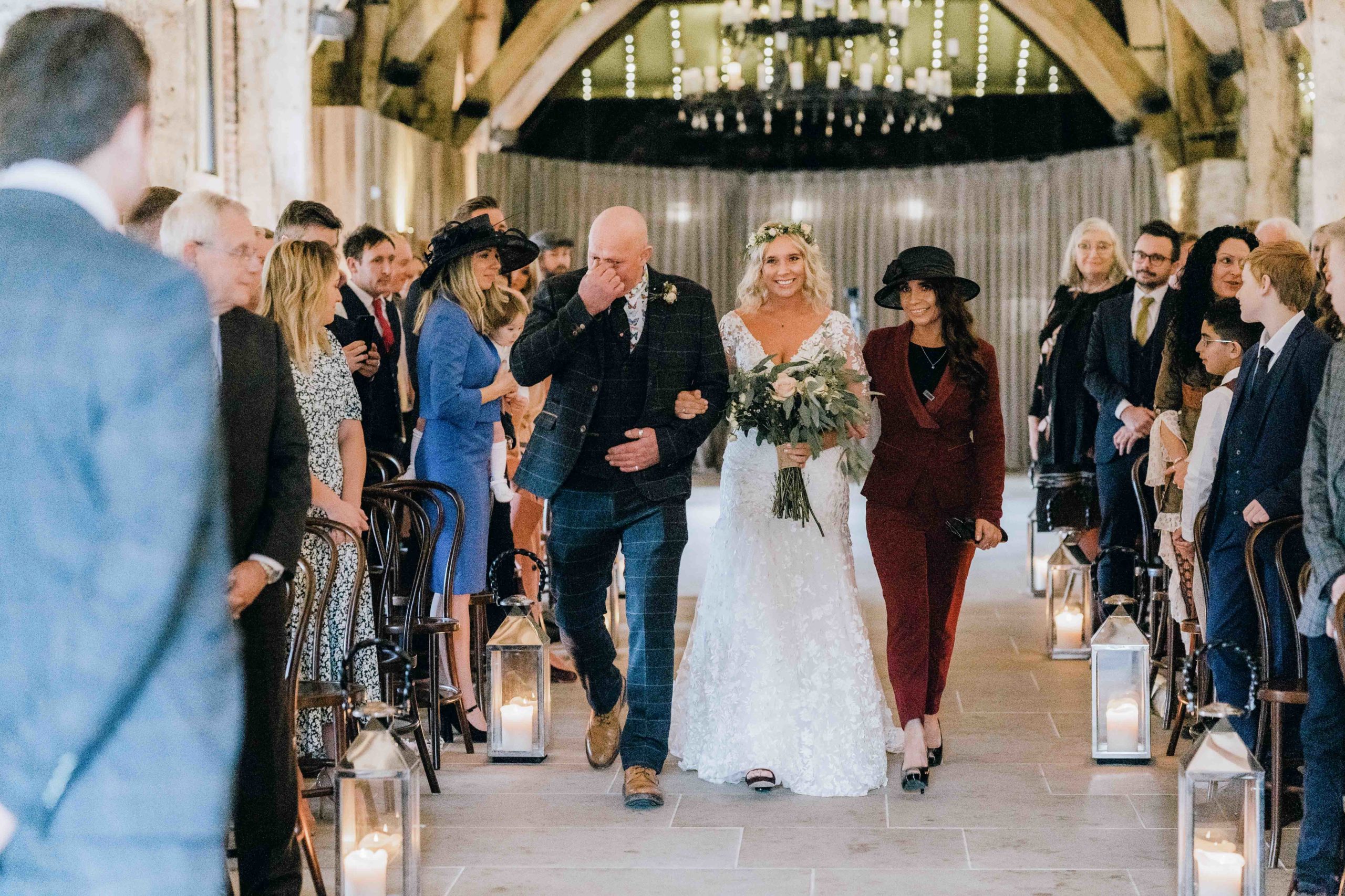 Bride walking down the aisle at the Tithe Barn