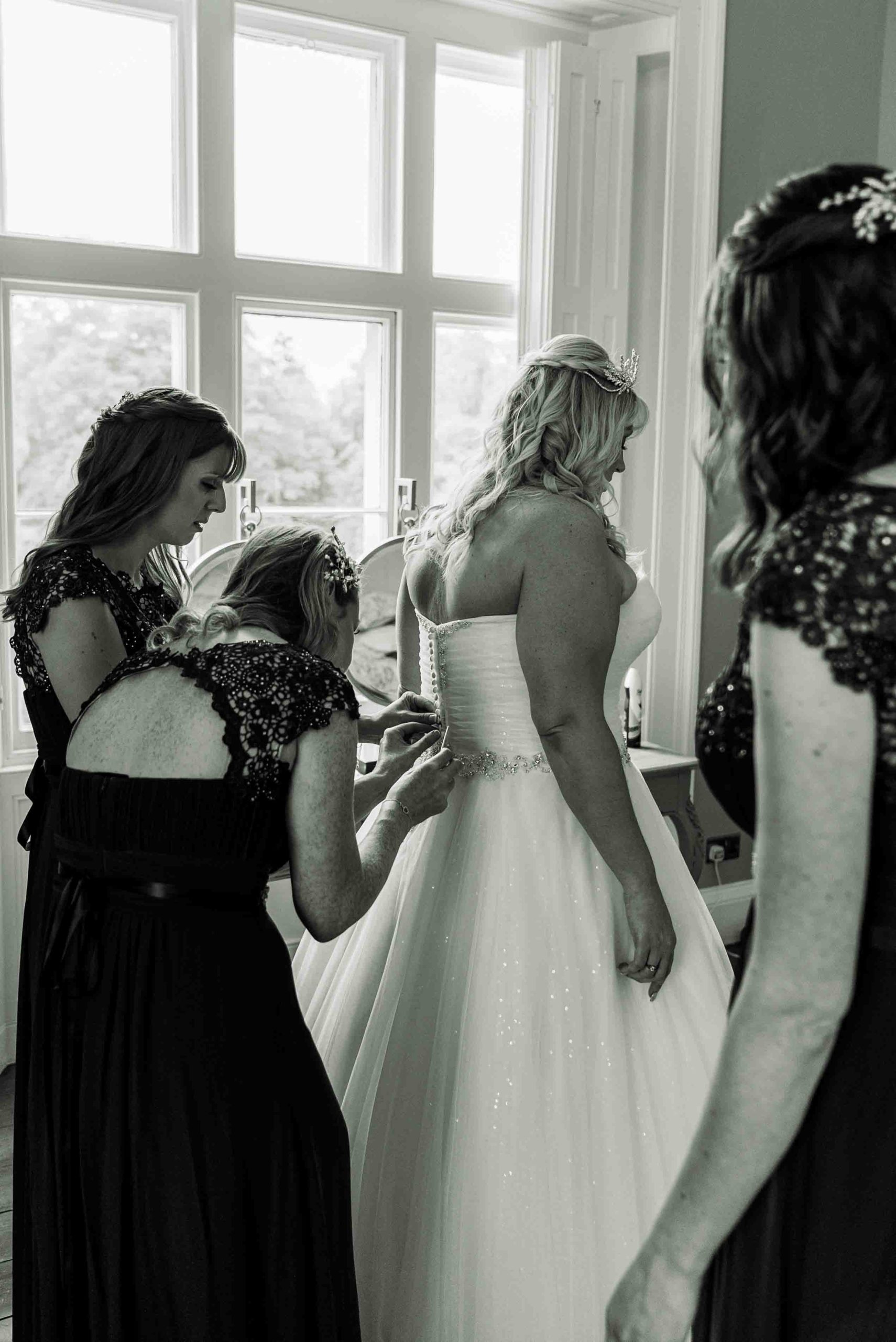 Charlotte having her dress buttoned up at Thicket priory
