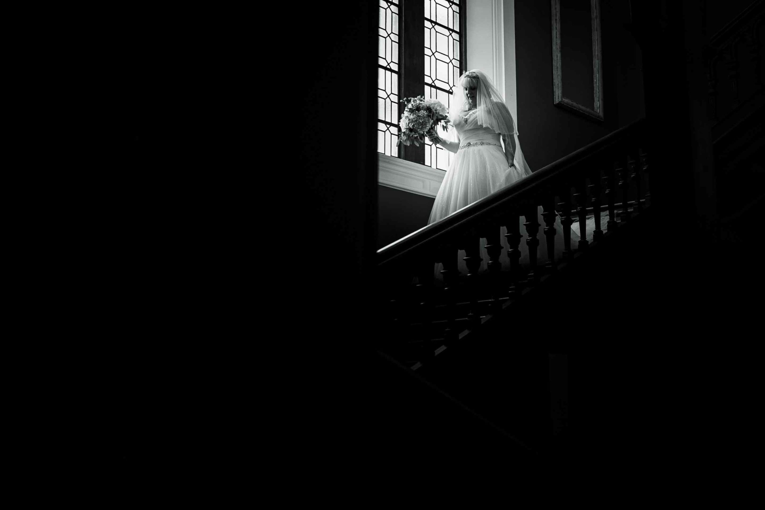 Bride on the stairs before wedding at Thicket Priory