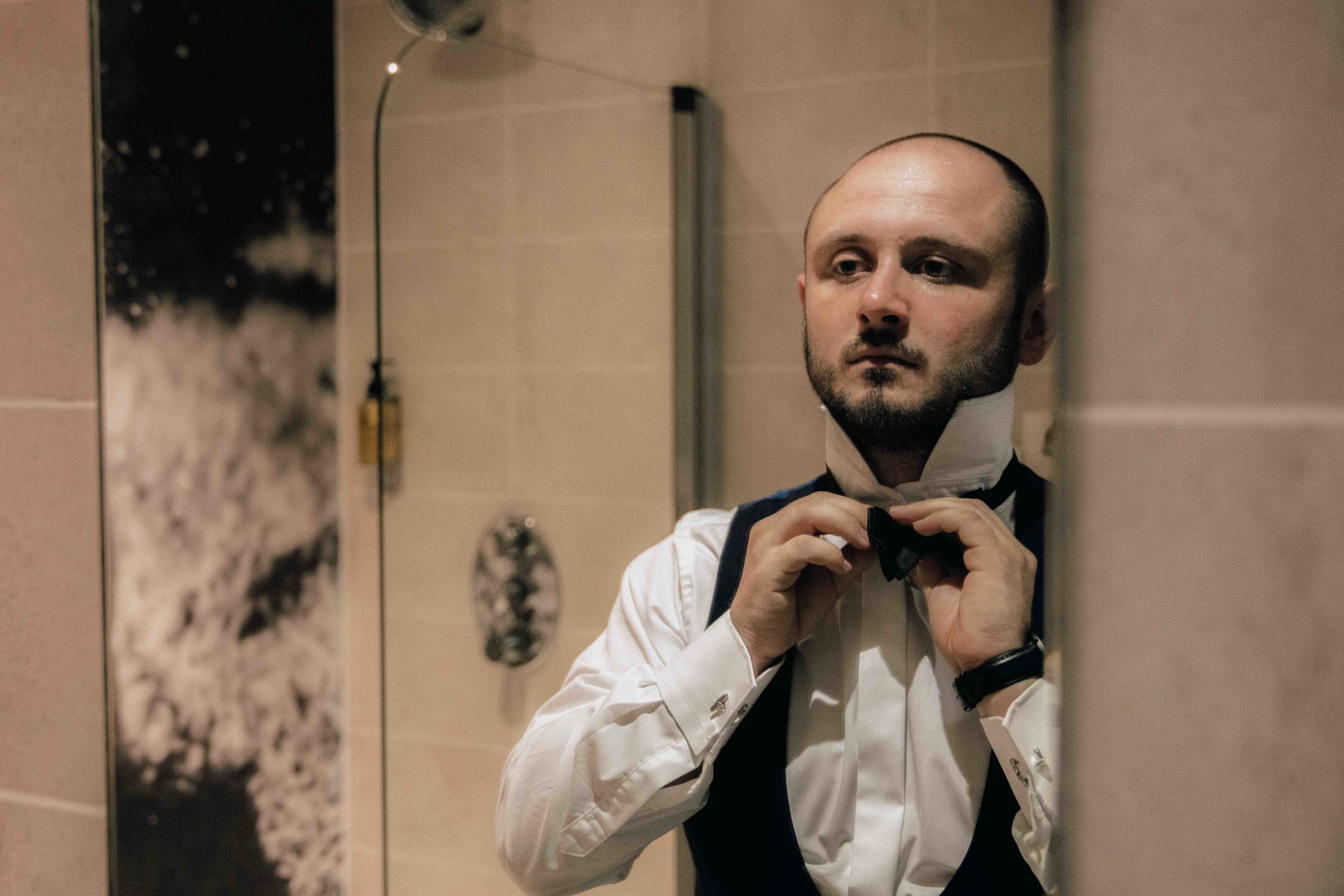 Arron straighten bow ties on the morning of his York wedding
