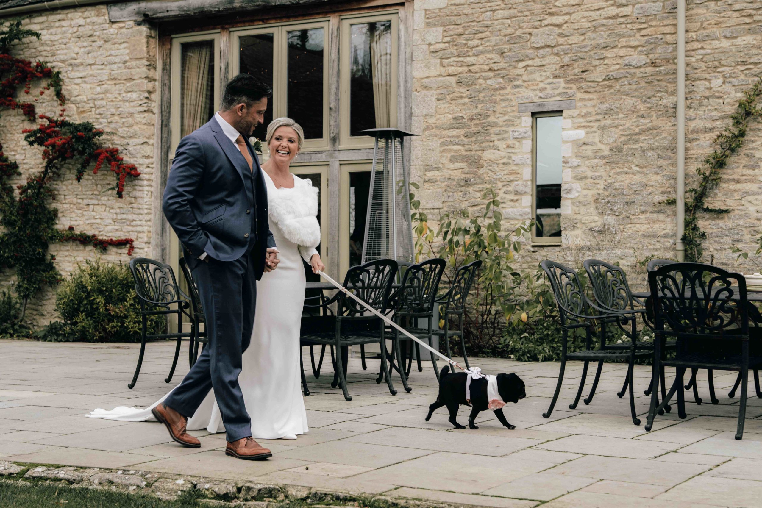Wedding couple walking their dog at Caswell house