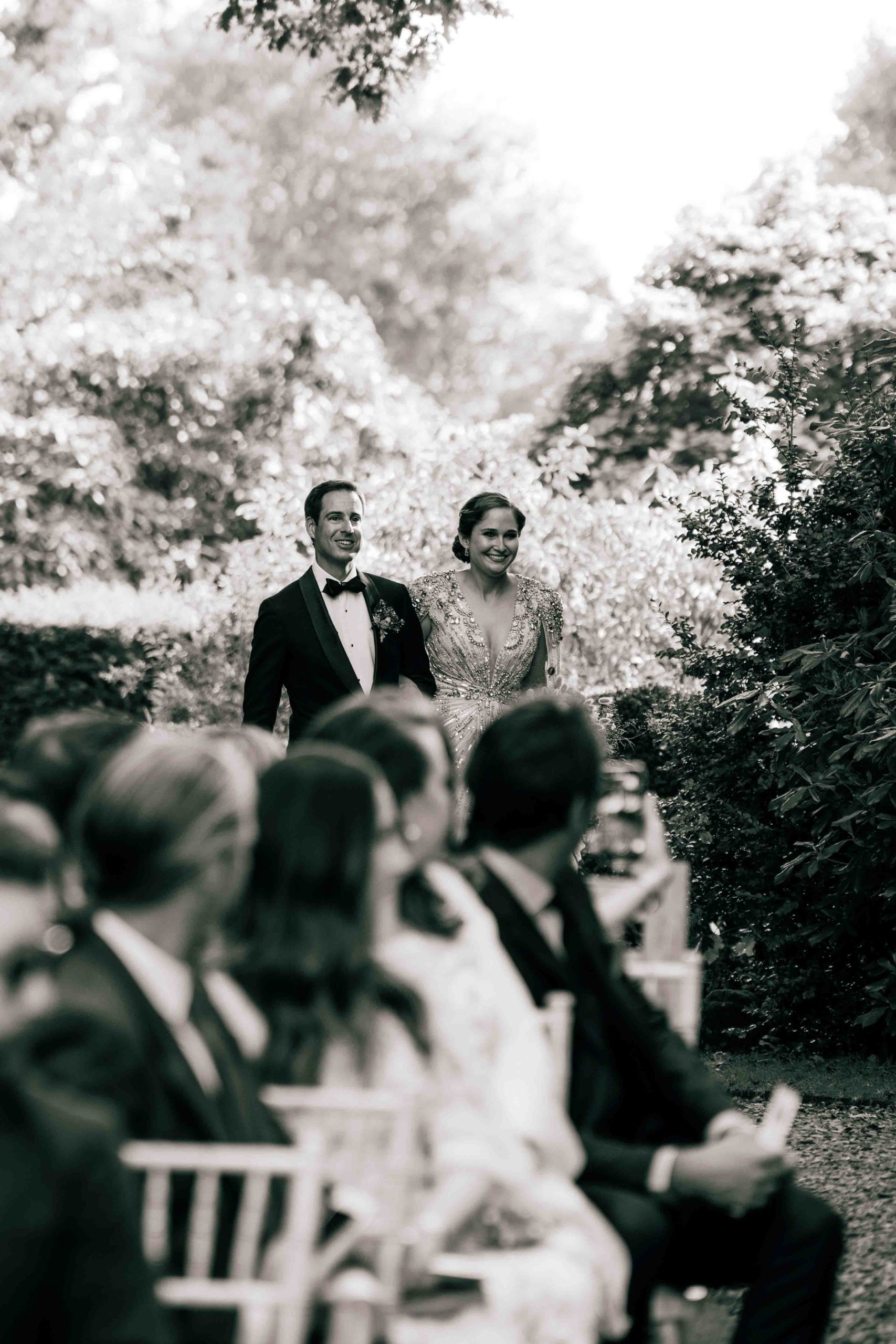 Bride and groom walking down the aisle at Broughton Hall