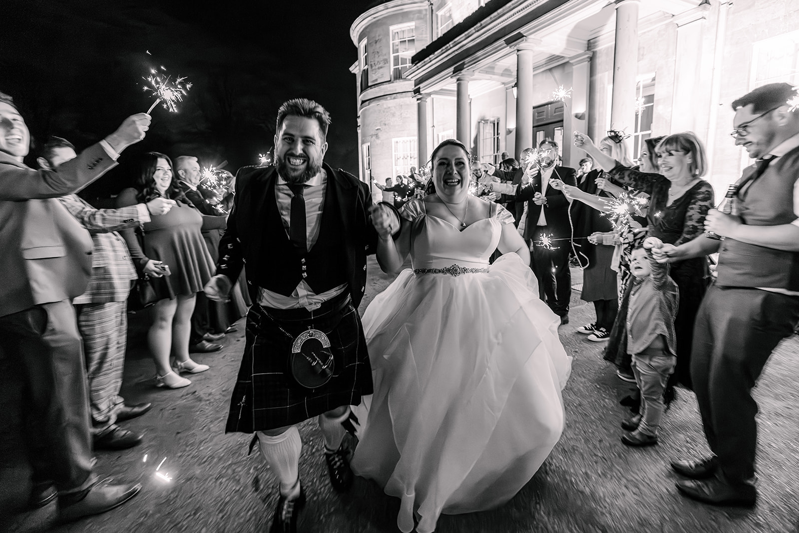 Running through sparklers at wedding