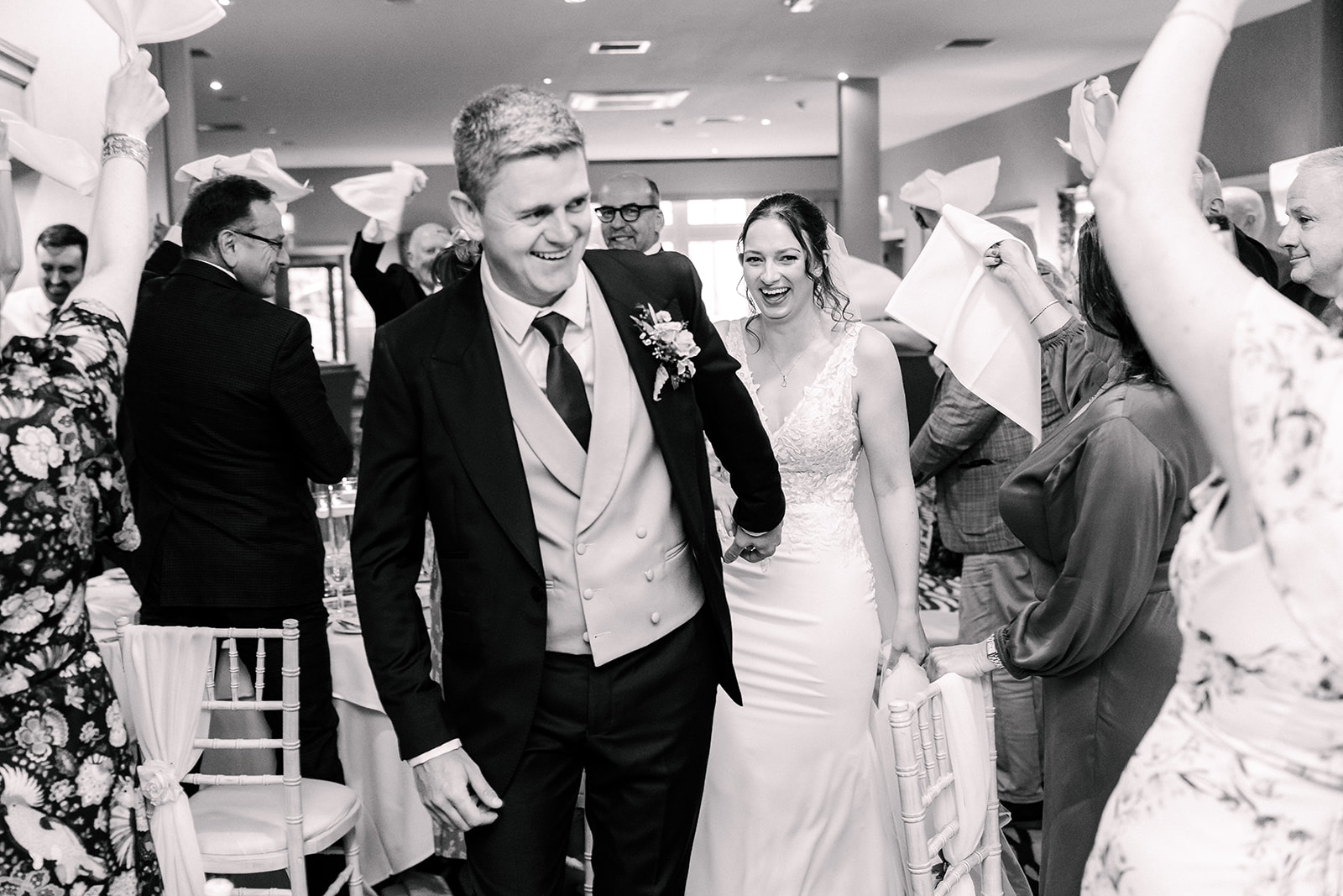 Couples uplifting entrance to wedding breakfast